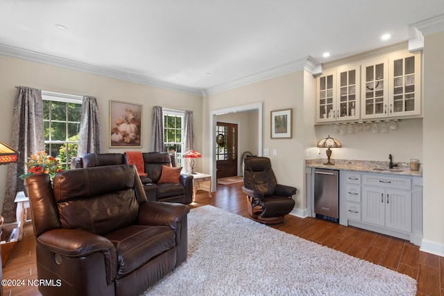 living room featuring ornamental molding, plenty of natural light, indoor wet bar, and dark hardwood / wood-style flooring