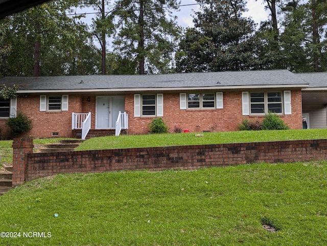 ranch-style home featuring a front lawn