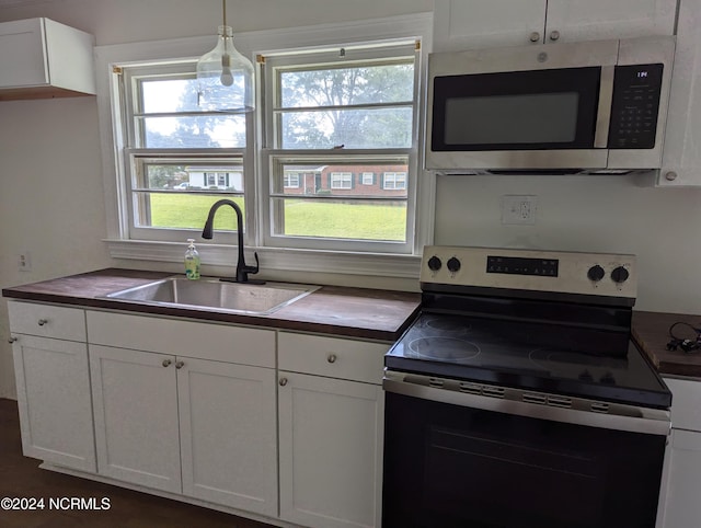 101 Kirkland Dr, Greenville, NC 27858 - kitchen with sink, electric range, decorative light fixtures, and white cabinets