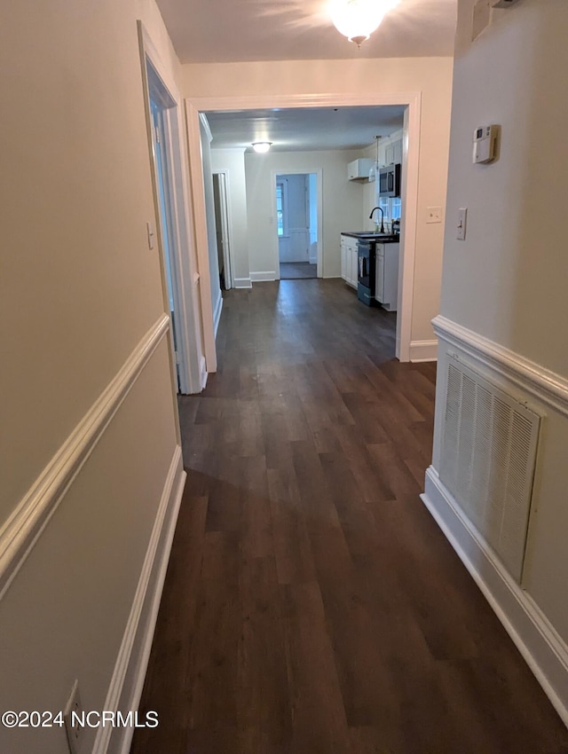 corridor featuring dark hardwood / wood-style floors