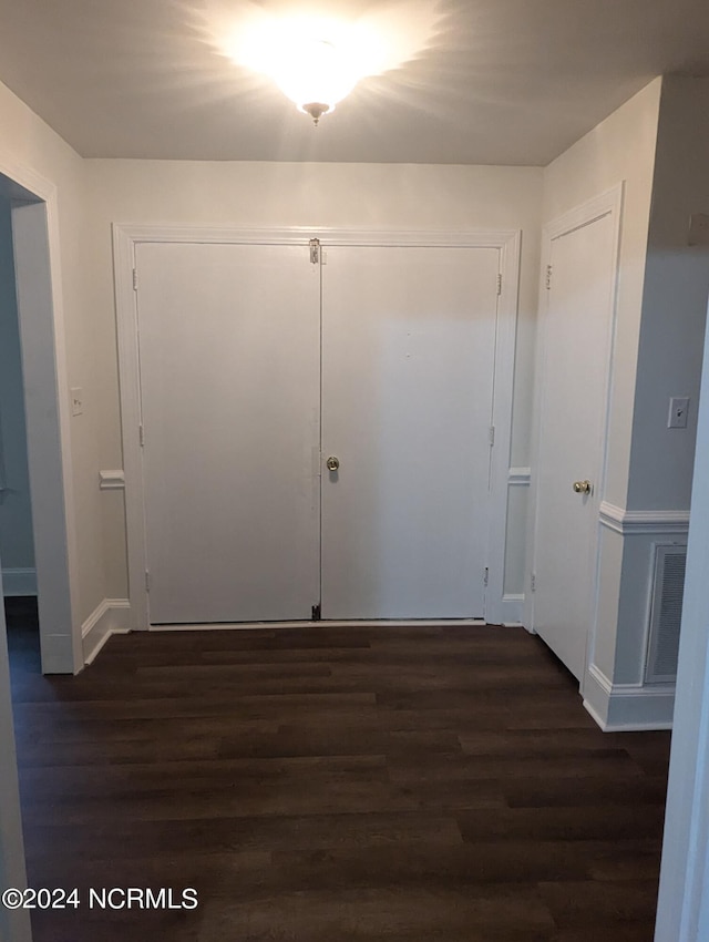 corridor featuring dark wood-type flooring