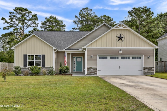 craftsman house featuring a garage and a front yard