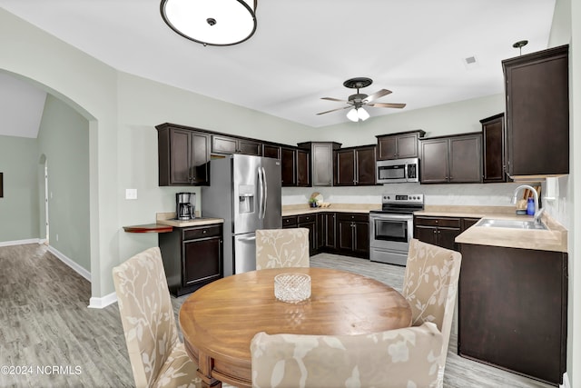 dining space featuring ceiling fan, light hardwood / wood-style floors, and sink