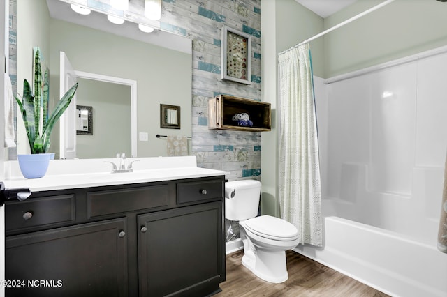 full bathroom with shower / tub combo, vanity, toilet, and wood-type flooring