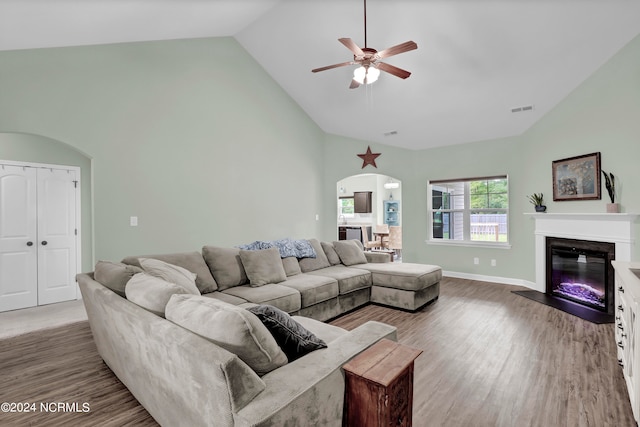 living room featuring high vaulted ceiling, ceiling fan, and hardwood / wood-style flooring