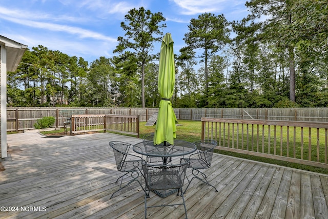 wooden terrace with a yard