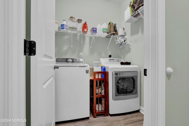 washroom with washer and dryer and hardwood / wood-style flooring