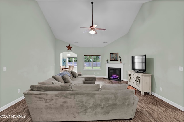 living room featuring ceiling fan, dark hardwood / wood-style floors, and high vaulted ceiling