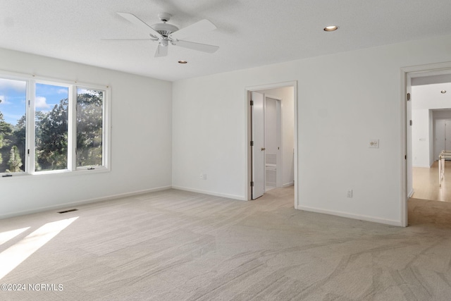 interior space featuring ceiling fan and light colored carpet