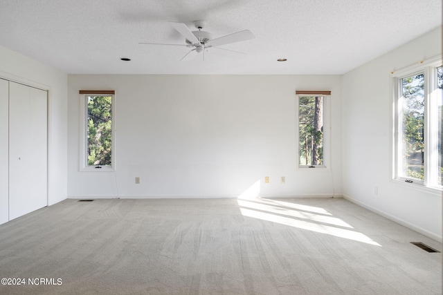 interior space featuring ceiling fan and a textured ceiling