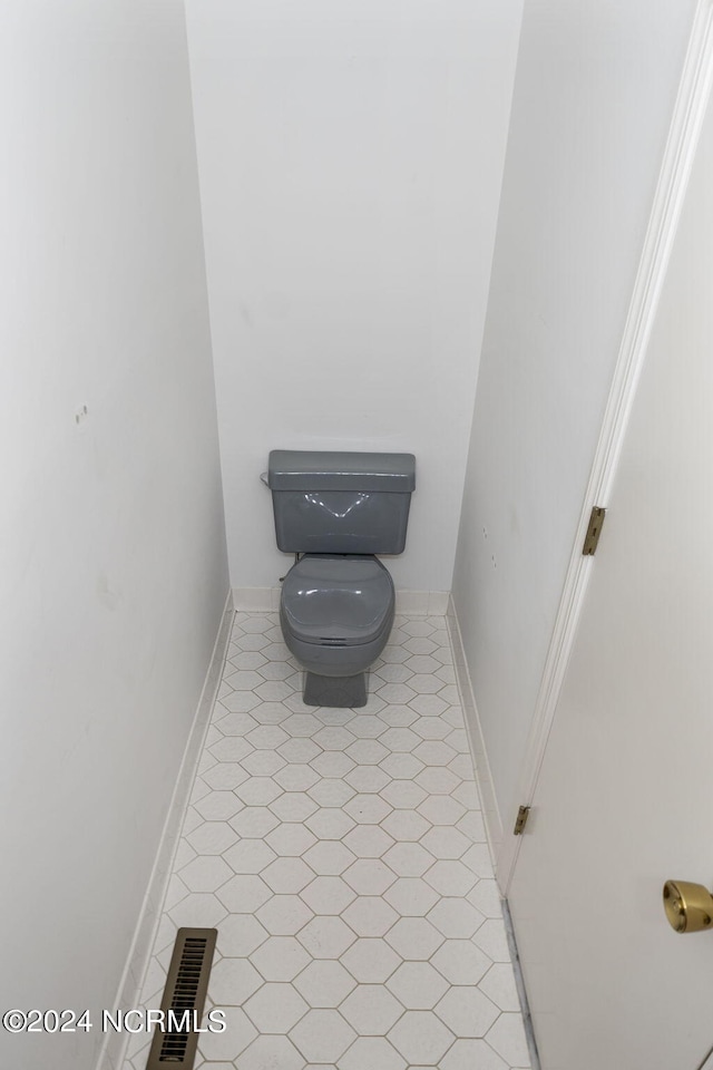 room details featuring toilet and tile patterned floors