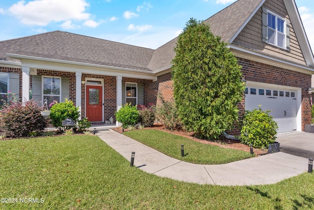 view of front of house with a garage and a front lawn