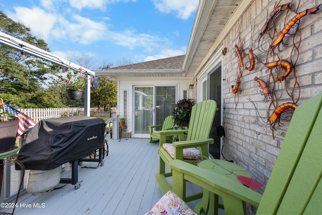 wooden terrace featuring area for grilling