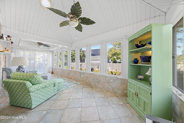 sunroom featuring ceiling fan and wooden ceiling