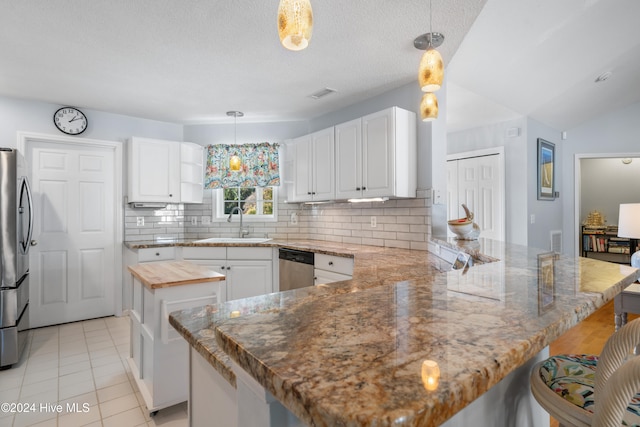 kitchen featuring white cabinets, hanging light fixtures, and a center island