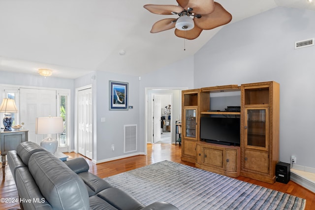 living room featuring light hardwood / wood-style floors, ceiling fan, and vaulted ceiling