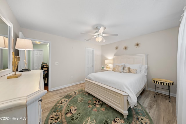 bedroom featuring light wood-type flooring and ceiling fan