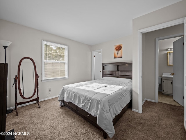 carpeted bedroom with connected bathroom and sink