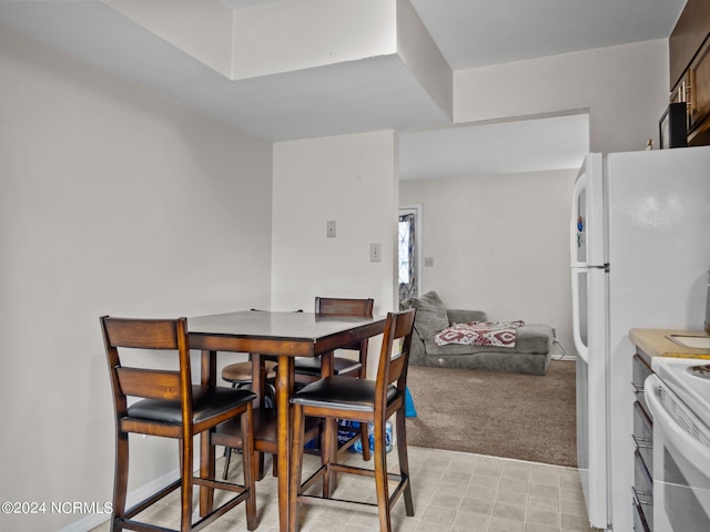 view of carpeted dining space