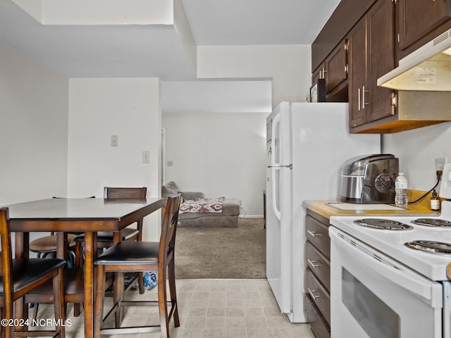 kitchen with dark brown cabinets, white electric range oven, and light carpet