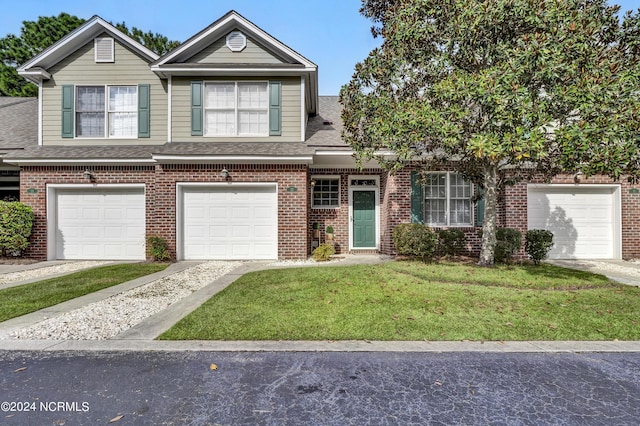 view of front of home with a garage and a front yard