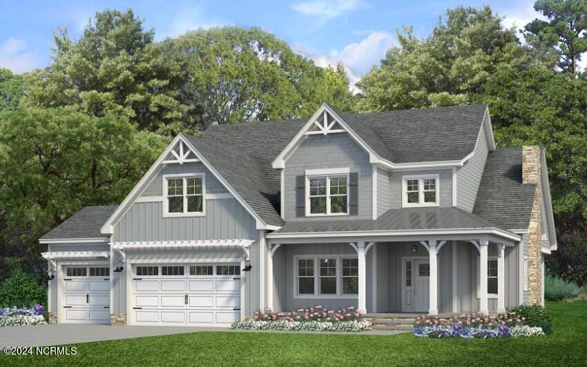 view of front of property featuring a front yard, a garage, and covered porch