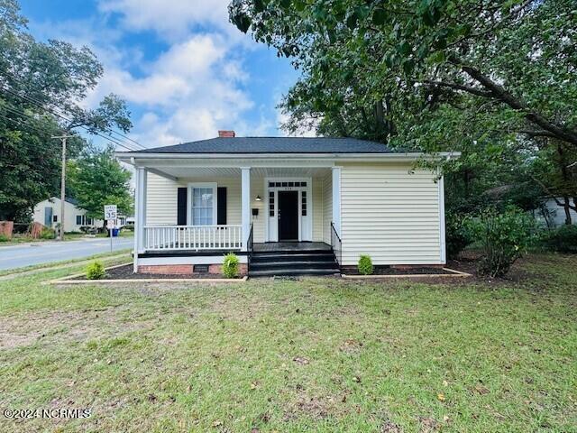 bungalow-style house featuring a porch and a front yard