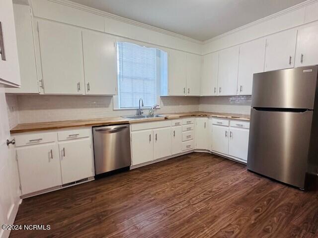 kitchen featuring white cabinets, appliances with stainless steel finishes, and sink