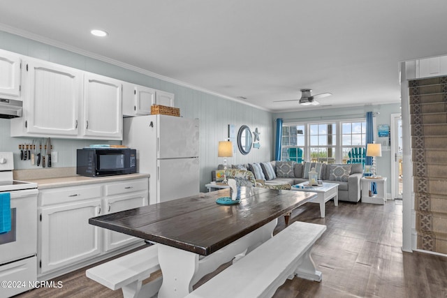 interior space featuring extractor fan, ceiling fan, white appliances, dark hardwood / wood-style floors, and white cabinets