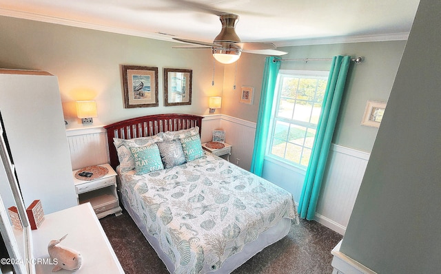 carpeted bedroom with ceiling fan and ornamental molding