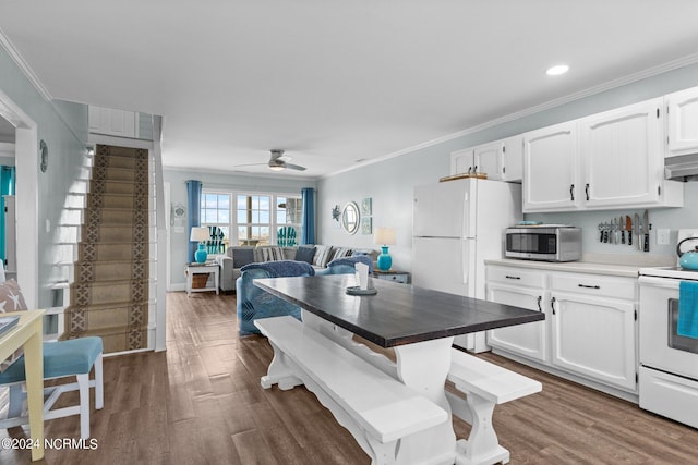 kitchen featuring dark hardwood / wood-style flooring, ceiling fan, white appliances, and white cabinets