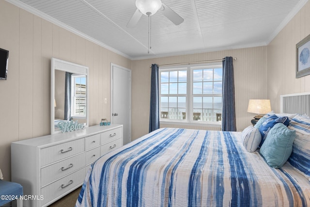 bedroom featuring ornamental molding, dark carpet, and ceiling fan