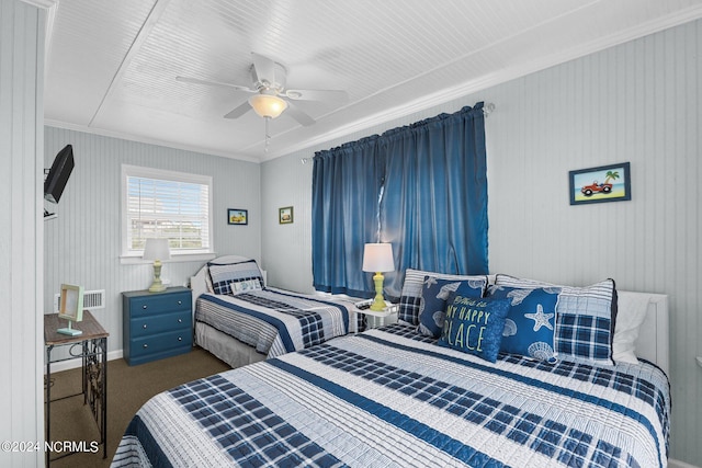 carpeted bedroom with ornamental molding and ceiling fan