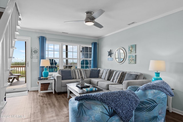 living room featuring ornamental molding, hardwood / wood-style flooring, and ceiling fan