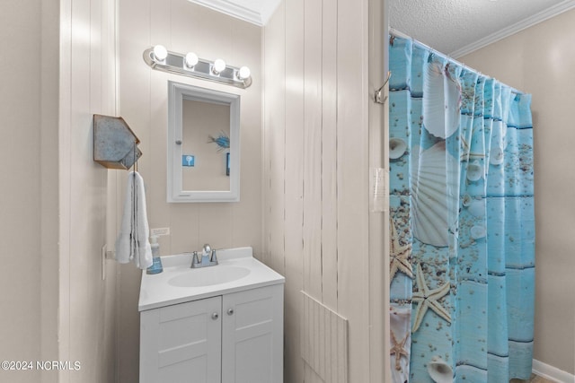 bathroom with walk in shower, ornamental molding, vanity, and a textured ceiling