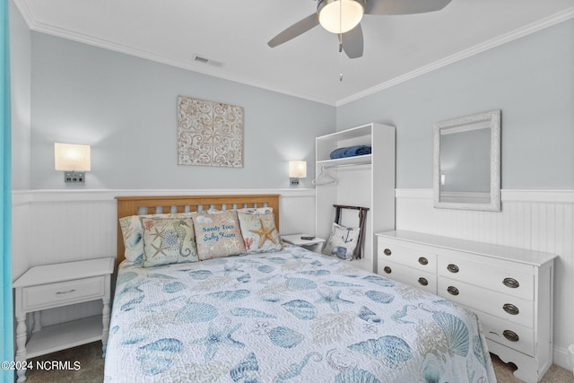 bedroom with ornamental molding, carpet, and ceiling fan