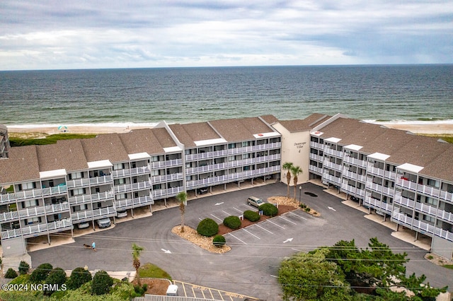 bird's eye view with a water view and a beach view