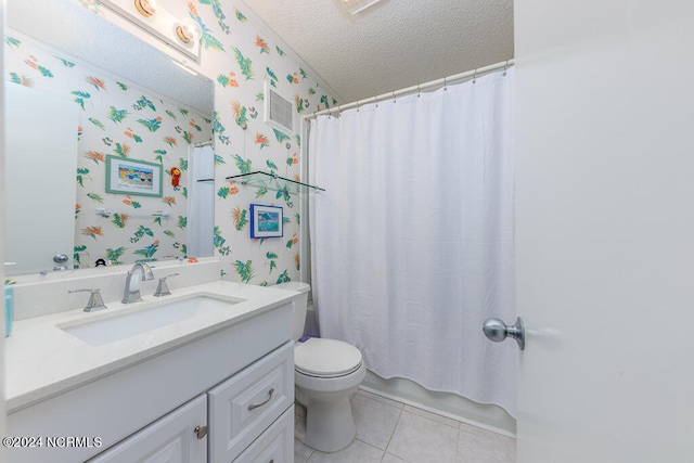 bathroom with a textured ceiling, vanity, toilet, and tile patterned floors