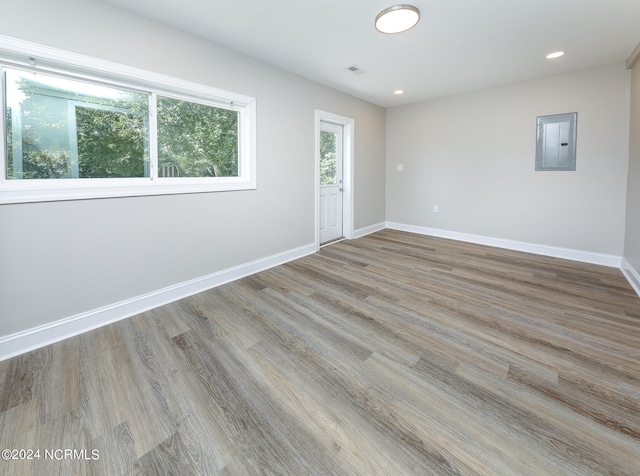 spare room featuring light hardwood / wood-style floors and electric panel