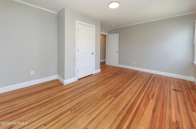 interior space featuring light hardwood / wood-style floors and ornamental molding