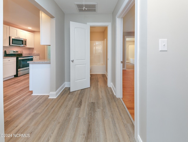 corridor featuring light hardwood / wood-style floors