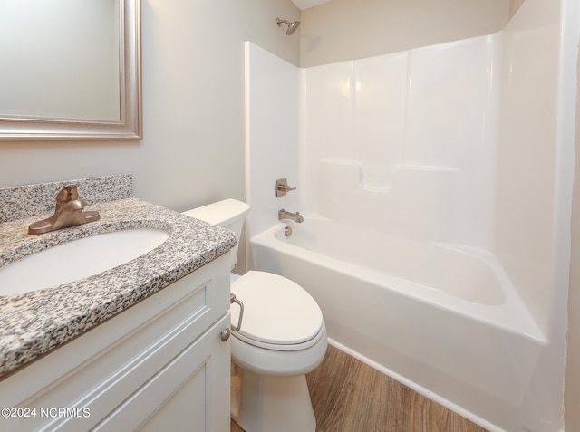 full bathroom with toilet, vanity, hardwood / wood-style floors, and bathtub / shower combination