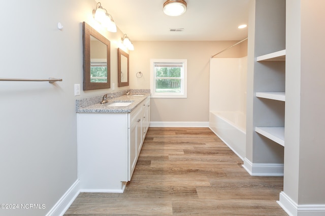 bathroom with vanity, hardwood / wood-style floors, and separate shower and tub