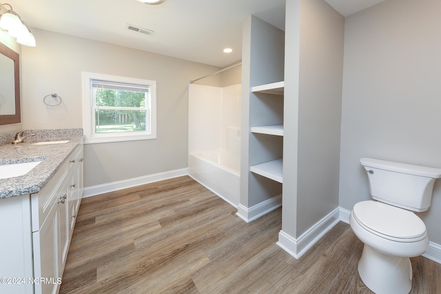 full bathroom with wood-type flooring, vanity, toilet, and bathtub / shower combination