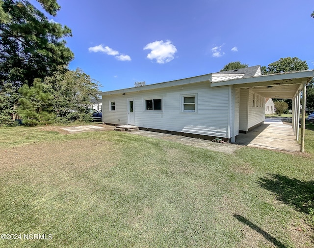 rear view of house with a yard