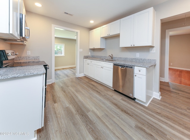 kitchen with light hardwood / wood-style floors, white cabinets, light stone countertops, stainless steel appliances, and sink