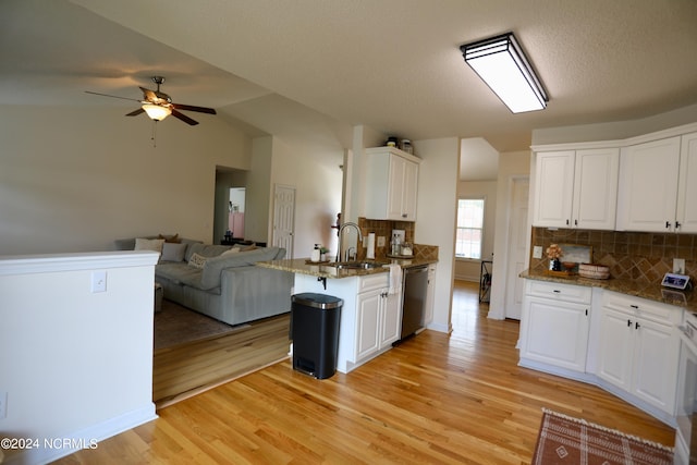 kitchen featuring light wood-type flooring, dishwasher, white cabinets, lofted ceiling, and kitchen peninsula