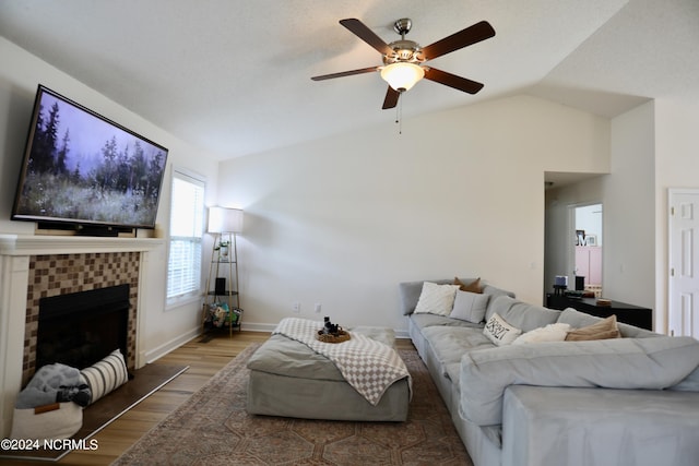 living room with vaulted ceiling, hardwood / wood-style floors, and ceiling fan