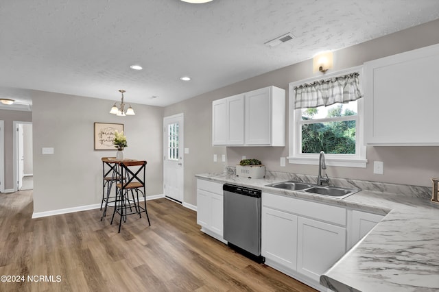 kitchen with light hardwood / wood-style floors, sink, white cabinetry, an inviting chandelier, and stainless steel dishwasher