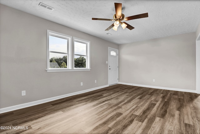 entrance foyer featuring a textured ceiling, hardwood / wood-style floors, and ceiling fan